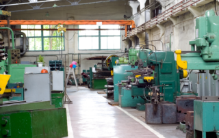 Industrial dust collection system capturing weld fumes and grinding particulates in a metal fabrication facility